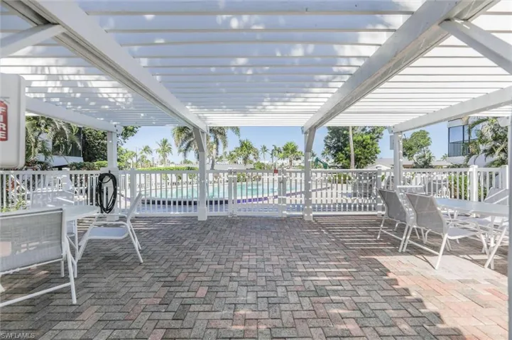 View of patio with outdoor dining space and a pergola