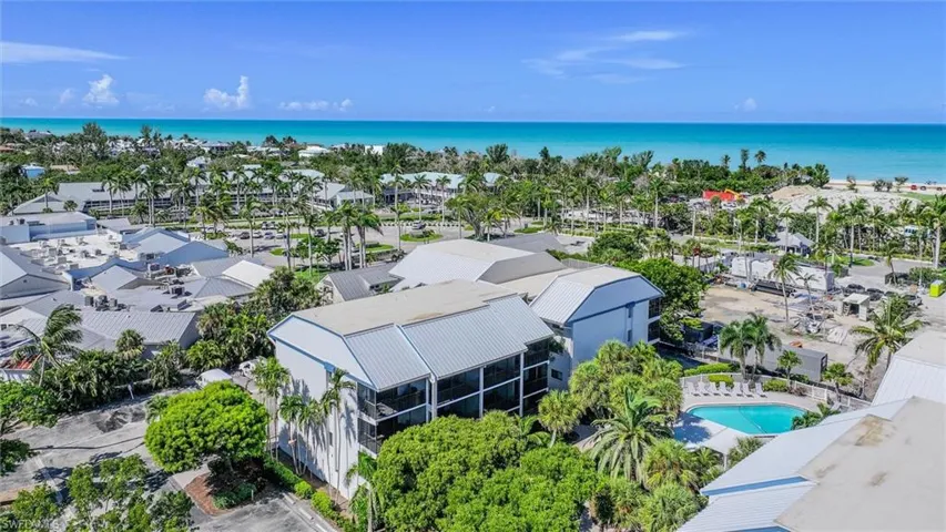 Aerial view of a nearby body of water and a pool area
