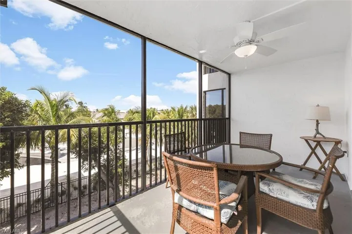 Sunroom featuring concrete floors and a wall of windows