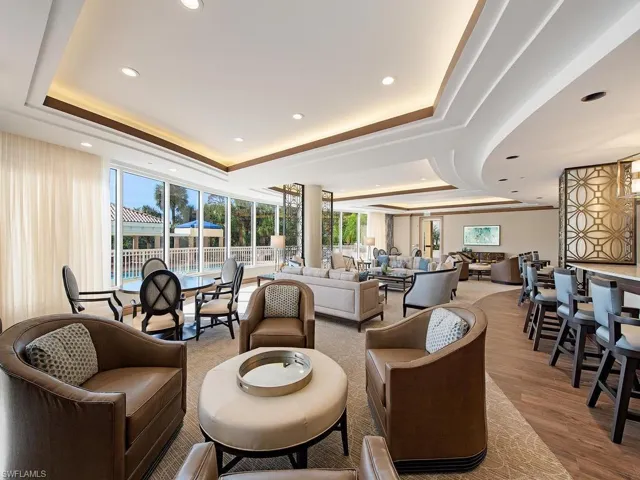 Community lobby featuring a raised ceiling and recessed lighting