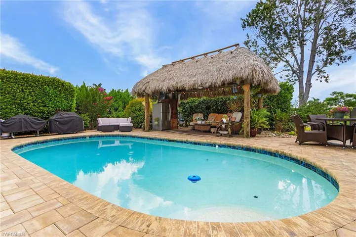 Outdoor pool featuring outdoor lounge area, a gazebo, a patio area, and area for grilling
