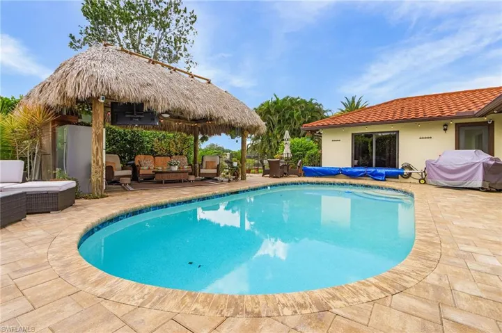 View of pool with outdoor lounge area, a patio area, a gazebo, and grilling area