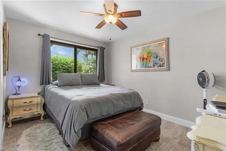 Bedroom featuring wood finish floors and ceiling fan