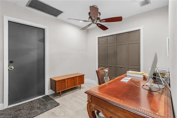 Office area with ceiling fan and light wood finished floors