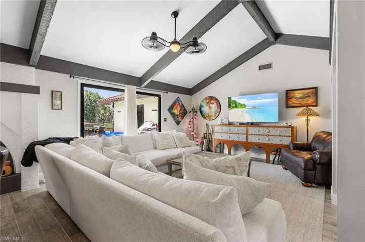 Living room with light wood-type flooring and ceiling fan