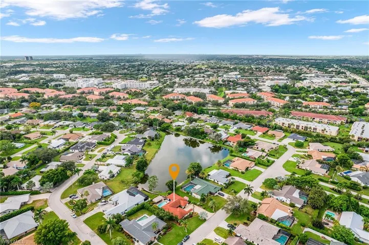 Aerial view of property's location with a nearby body of water and nearby suburban area