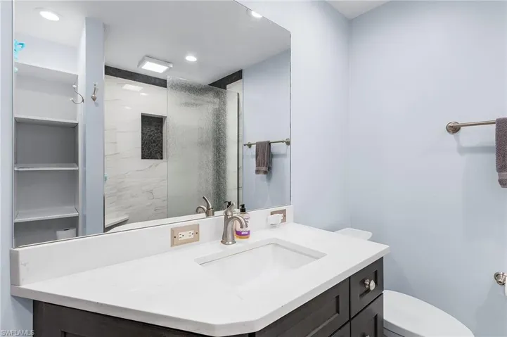 Bathroom featuring a stall shower and vanity