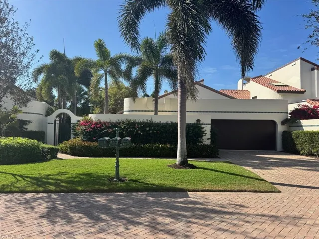 Mediterranean / spanish-style home with a garage and a front yard