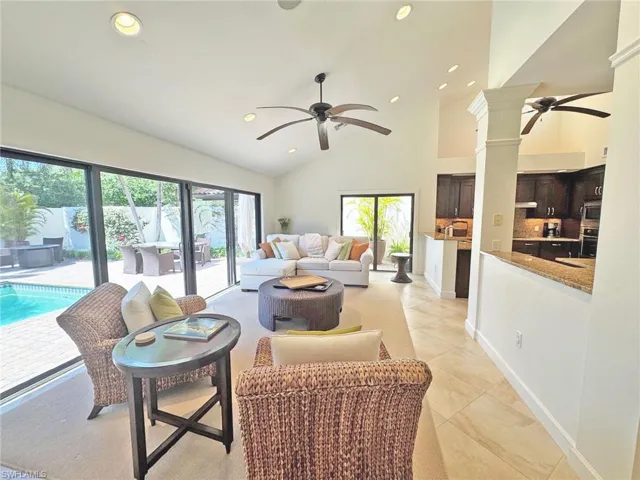 Living area featuring a ceiling fan, recessed lighting, and a wealth of natural light