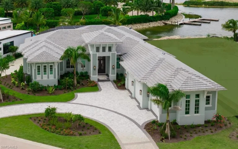 View of front of house featuring a water view and a front lawn