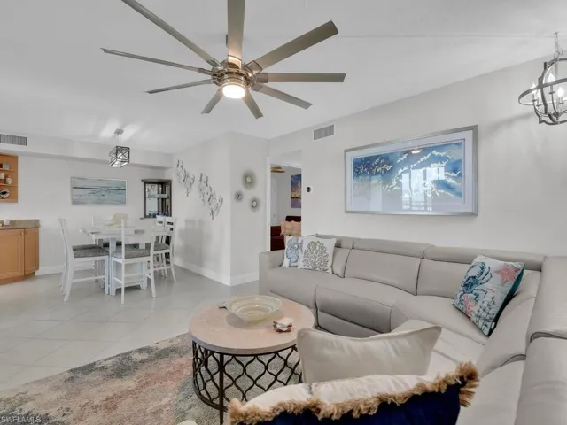 Living area featuring light tile patterned floors and a chandelier
