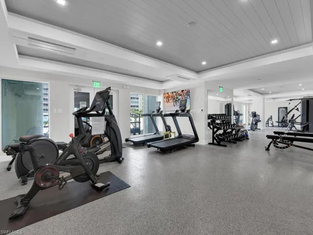 Exercise room with wooden ceiling and recessed lighting