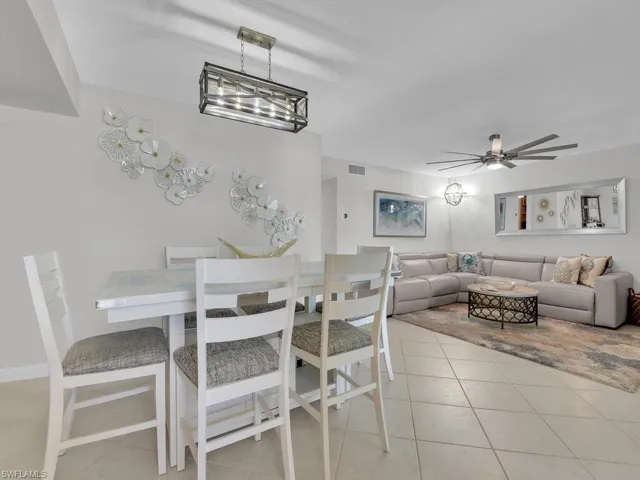 Dining area with light tile patterned flooring and ceiling fan