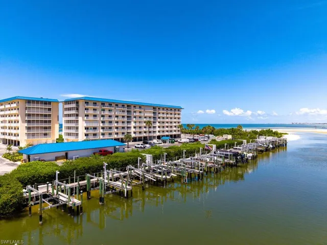 Water view featuring boat lift, a dock, and a marina
