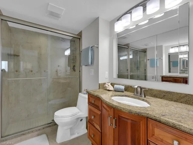 Full bathroom featuring vanity, a shower stall, and light tile patterned floors
