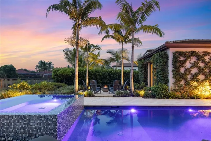 Pool at dusk featuring a patio area