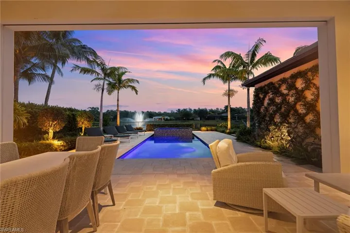 Pool at dusk with a patio area