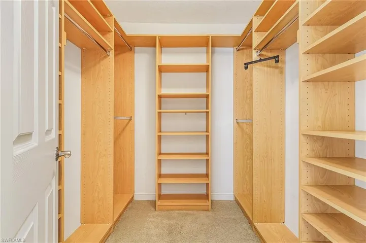 The main bedroom has two closets, this picture is of the walk-in's custom closet system.