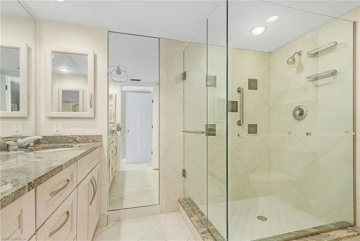 The main bathroom has dual sinks, raised vanity with granite top, beautifully tiled walk-in shower and new toilet.