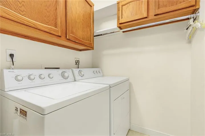 Laundry room is inside the home with wood cabinetry.