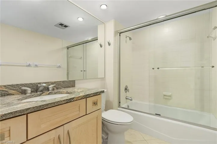 Ensuite bath with elevated vanity, granite countertop and new toilet.