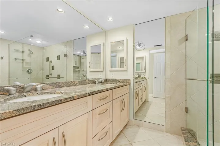 The Main bathroom features a raised vanity with granite countertops and dual sinks.