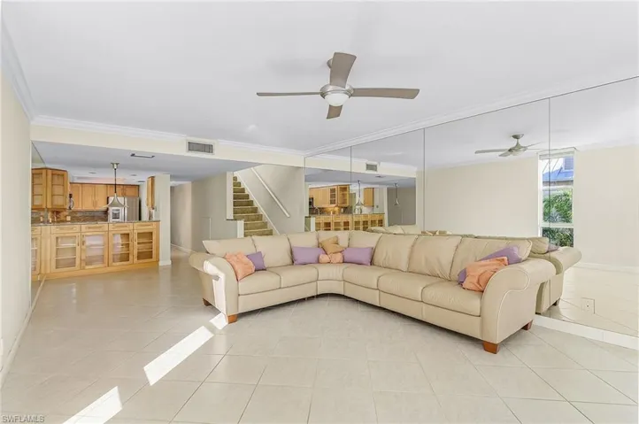 Beautiful, light tile on the diagonal and crown molding run throughout the main living floor of the home.