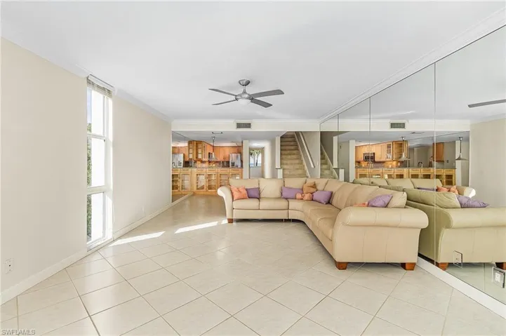 The view of the living room with the dining area and kitchen in the background.