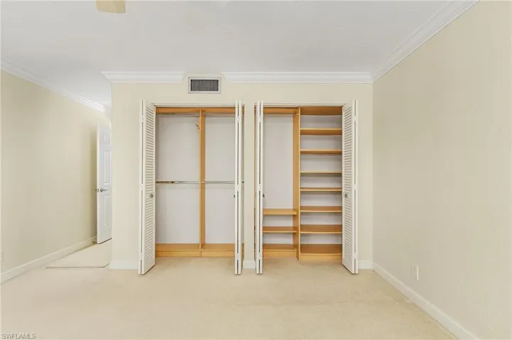 Upper floor guest bedroom provides ample storage for overnight guests with the Dual closets's custom system.