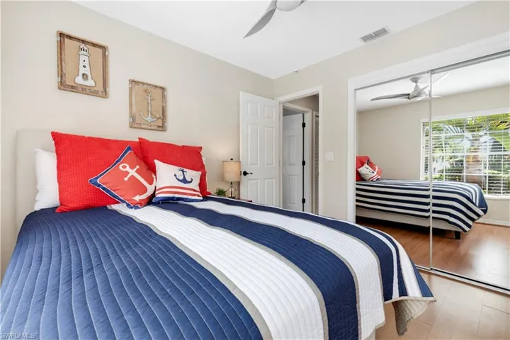Bedroom #4 featuring wood finished floors, a ceiling fan, and a closet