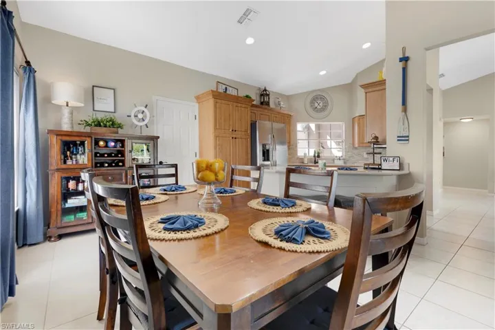 Dining room featuring light tile patterned floors, recessed lighting, and vaulted ceiling