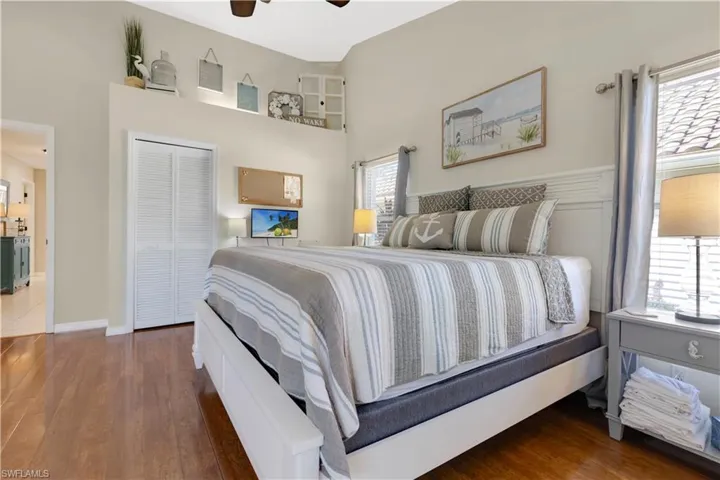 Master Bedroom with wood finished floors, a closet, a high ceiling, and ceiling fan