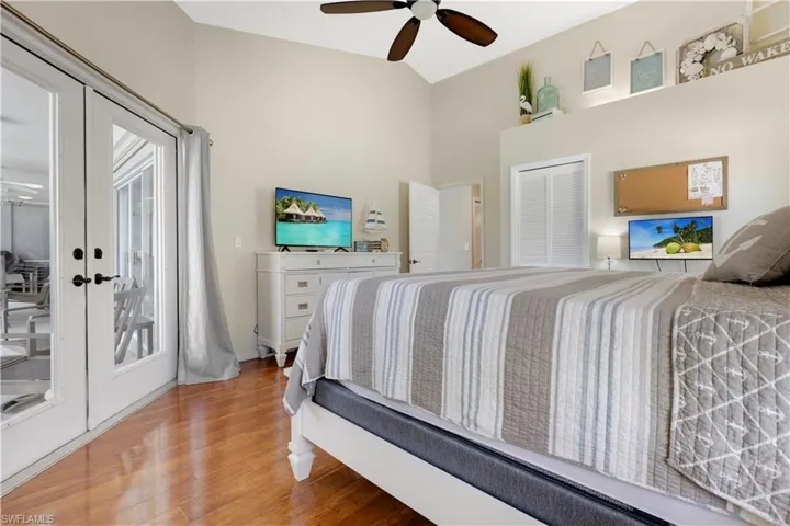 Master Bedroom featuring french doors, light wood-style floors, access to outside, a closet, and vaulted ceiling