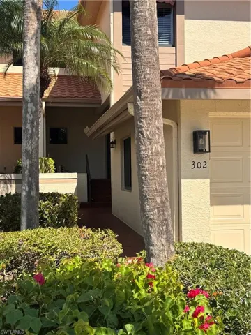 Stucco exterior with a tiled roof and integrated garage