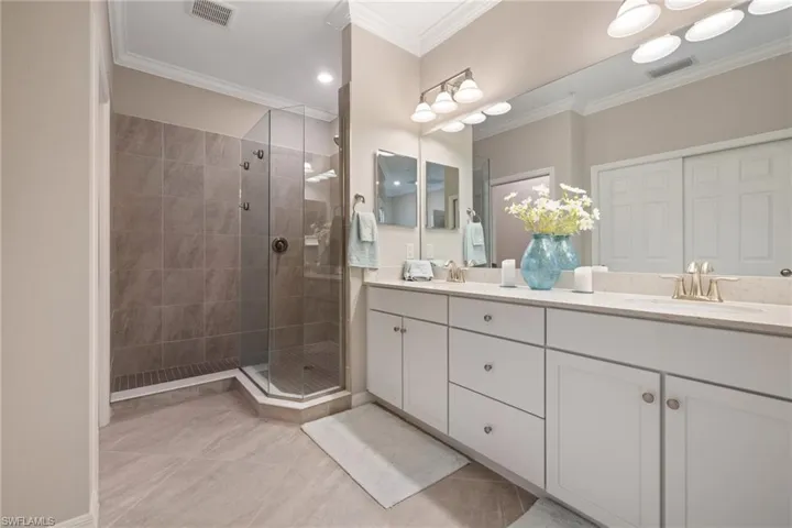Primary bathroom with dual sinks and walk in shower