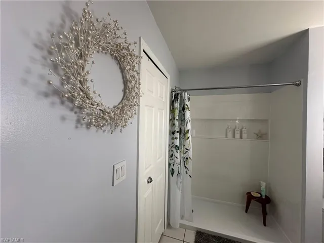 Bathroom featuring tile patterned floors and a shower with shower curtain