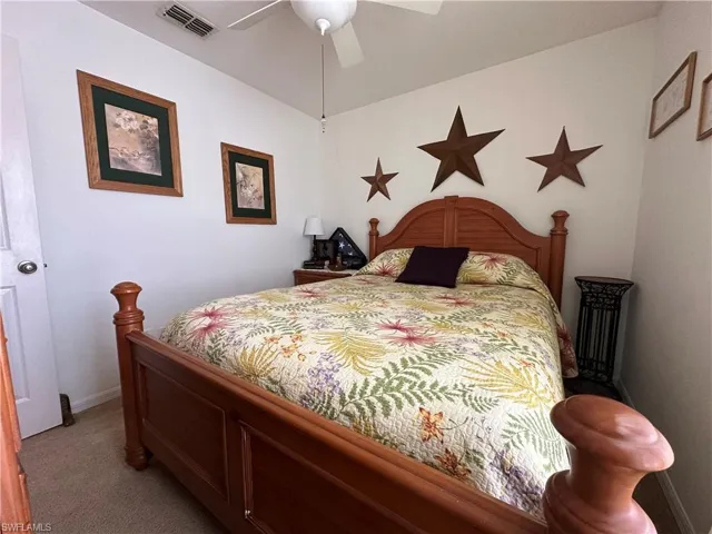 Carpeted bedroom with ceiling fan