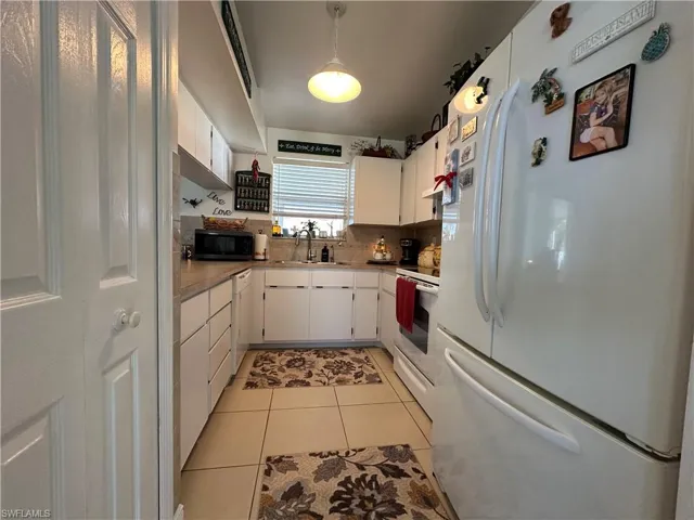 Kitchen with Window over the sink looking into the backyard