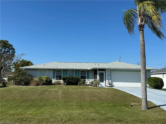 Single story home with a screened front entry & 2 car garage