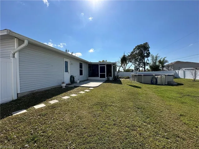 Rear view of house with outdoor deck & Entrance to Pool Bathroom