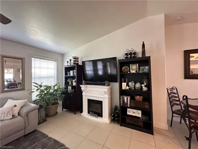 Living room featuring tile flooring and  Vaulted ceiling