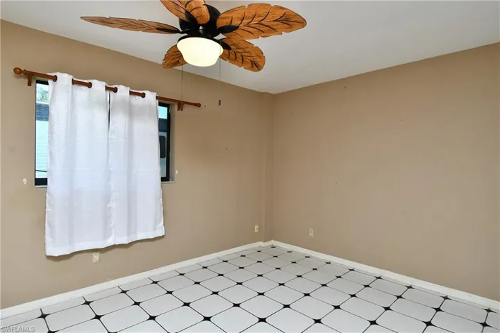 Spare room with a ceiling fan and light floors