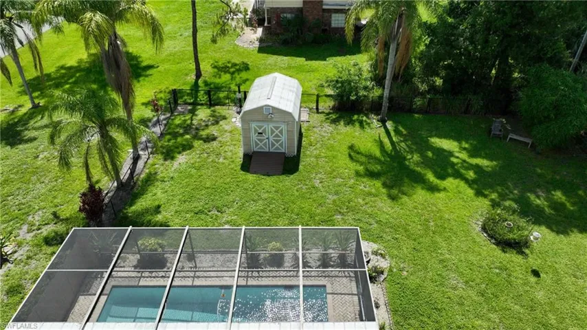 Fenced backyard with a storage shed