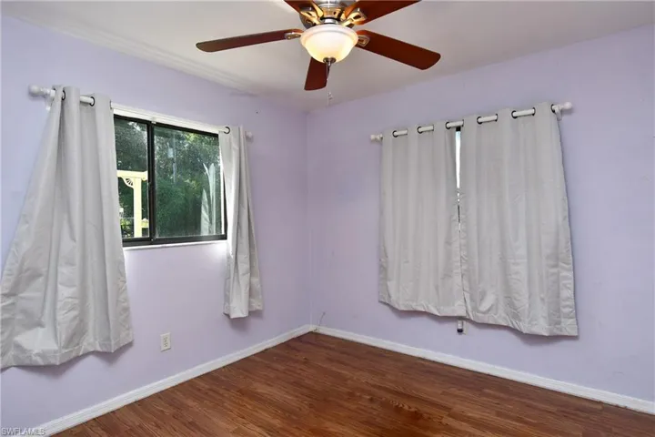 Spare room featuring wood finished floors and ceiling fan