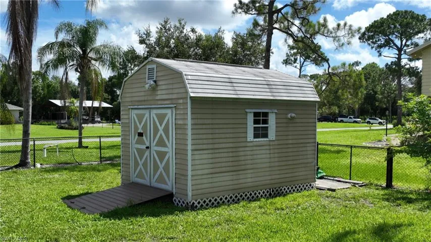 View of shed with a fenced backyard