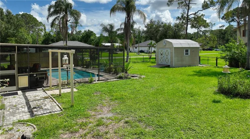 Fenced backyard with a storage shed