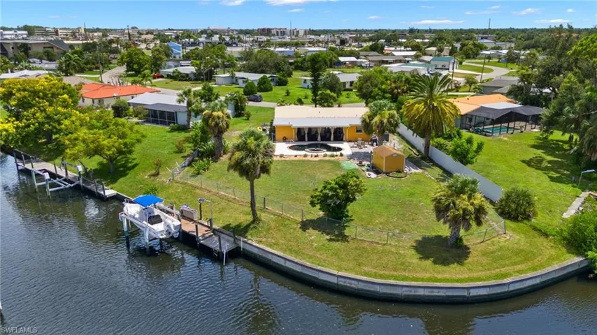 Birds eye view of property with a water view
