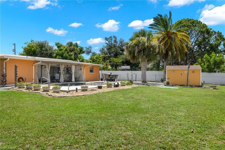 View of yard with a patio area and a storage unit
