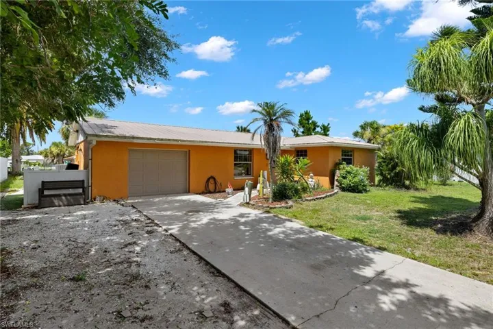 Ranch-style home with a front lawn and a garage