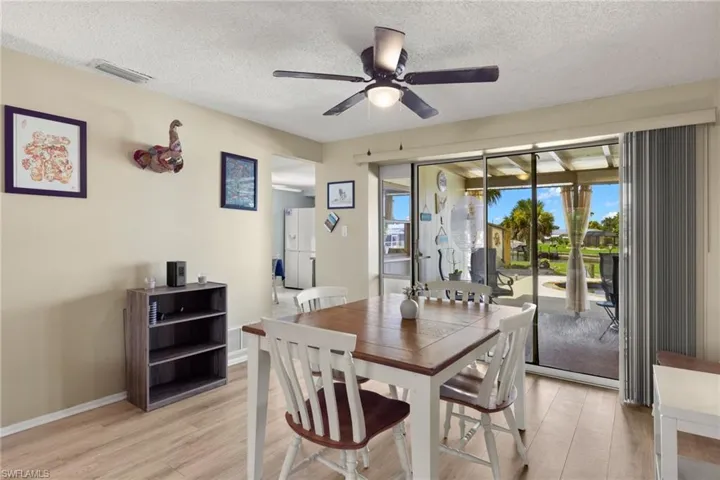 Dining area featuring a textured ceiling, ceiling fan, and light hardwood / wood-style floors